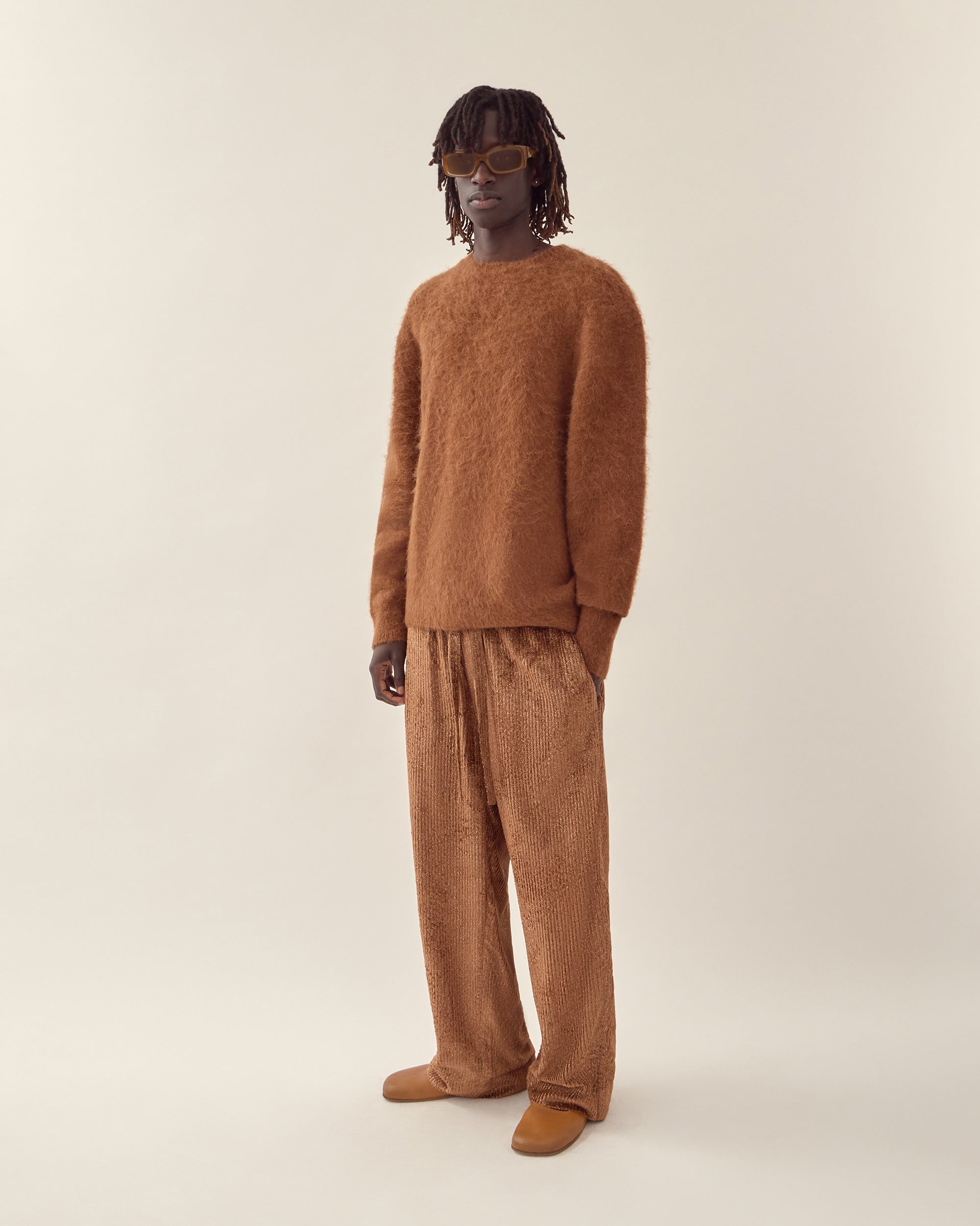 side view of men's burnt orange corduroy trouser in orange.