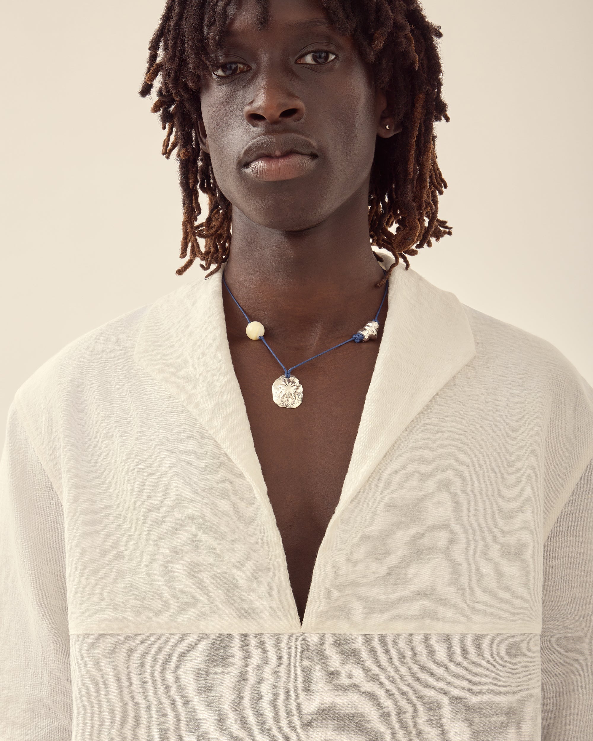 Close view of men's nautical shirt in white.