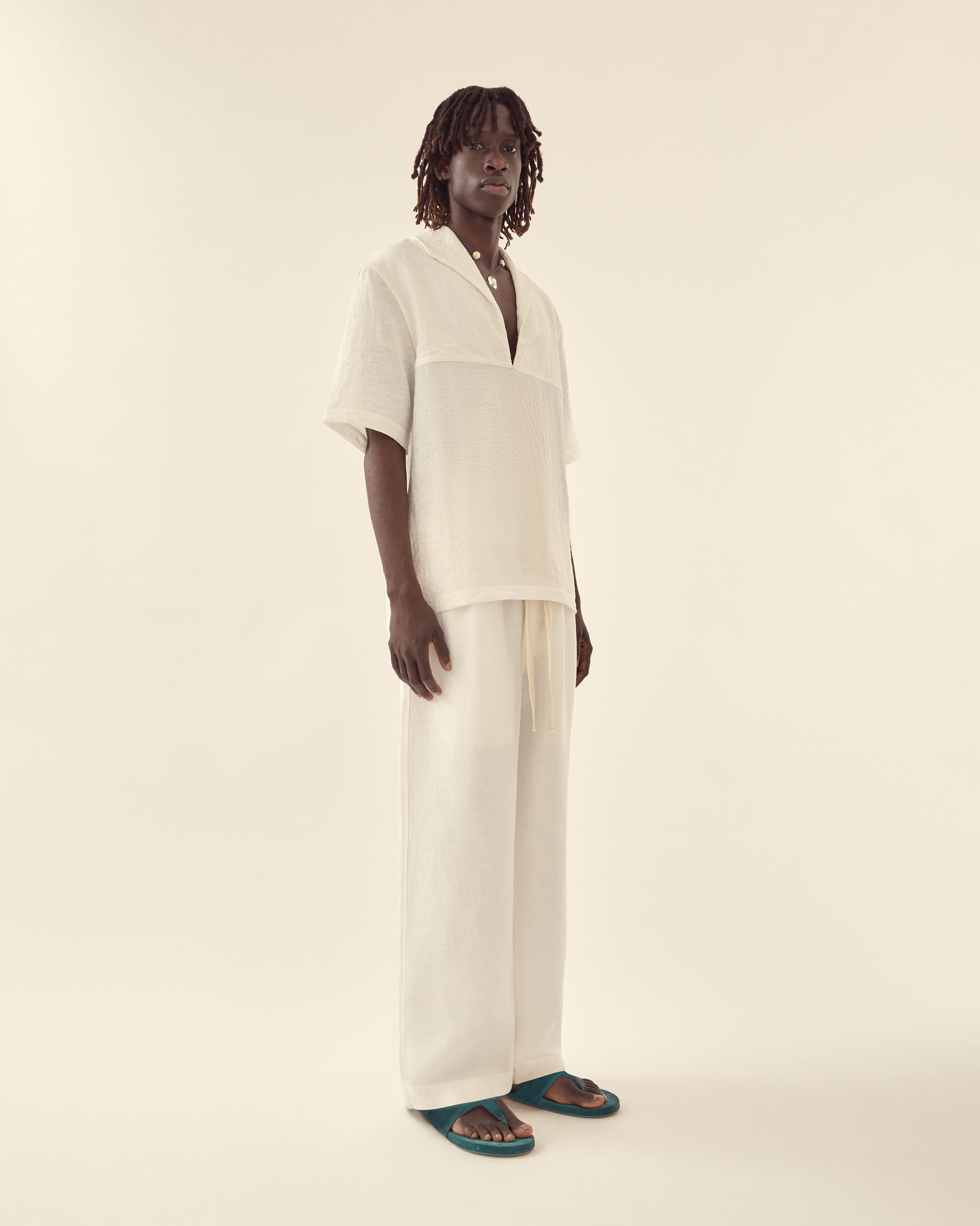 Side view of men's nautical shirt in white.