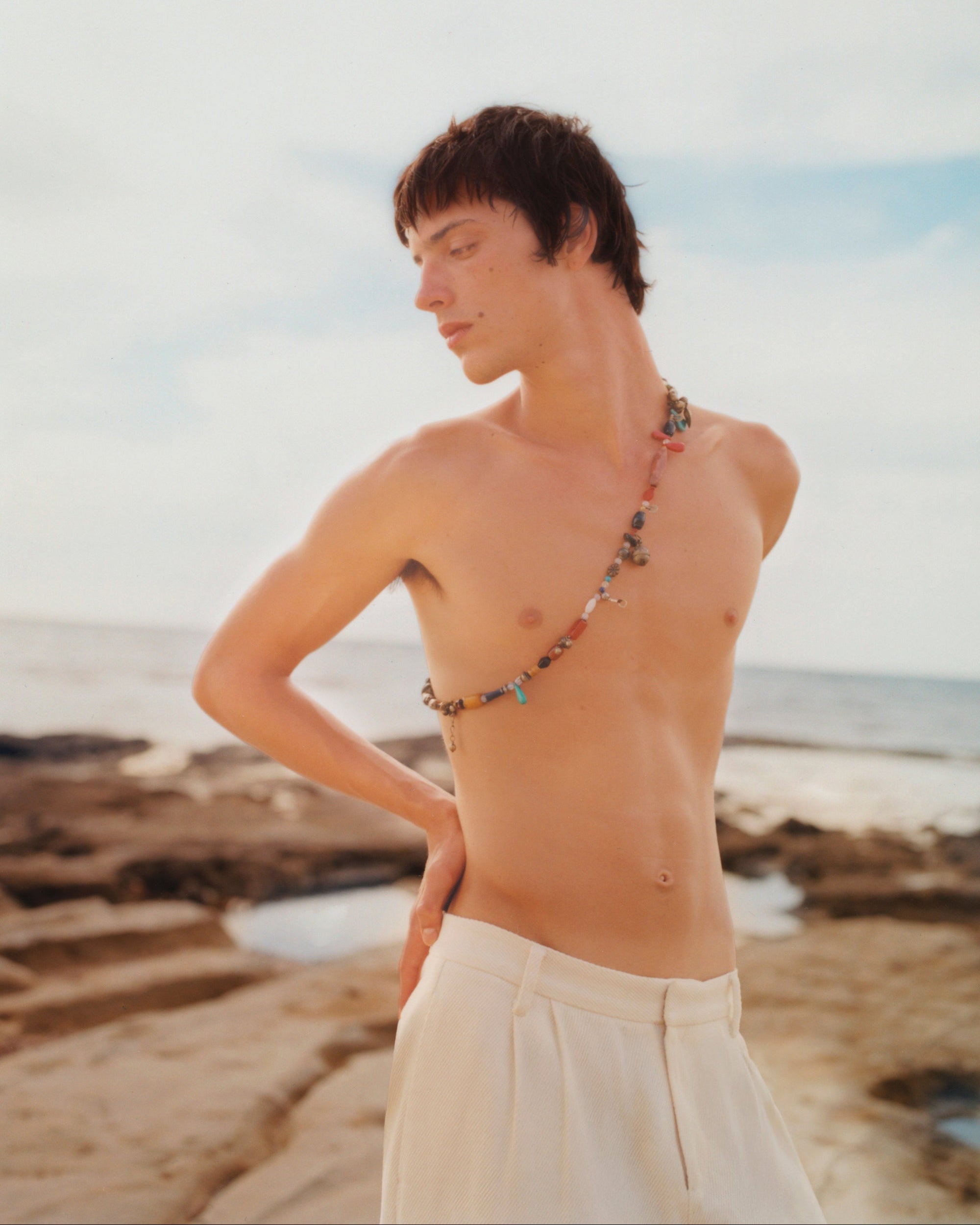 Campaign image of men's tailored white trousers.