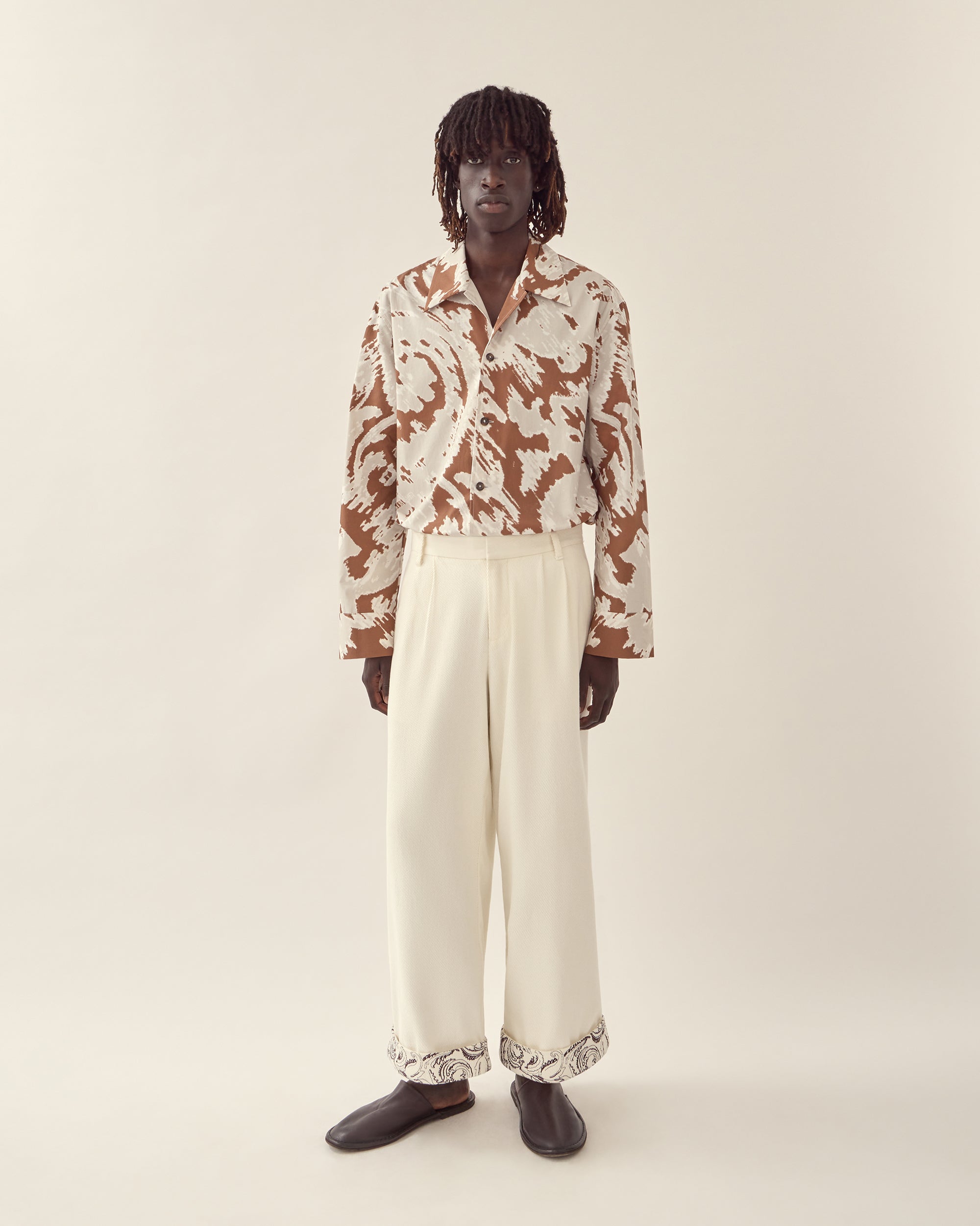 front view of paisley embroidered cuff trouser in cream.