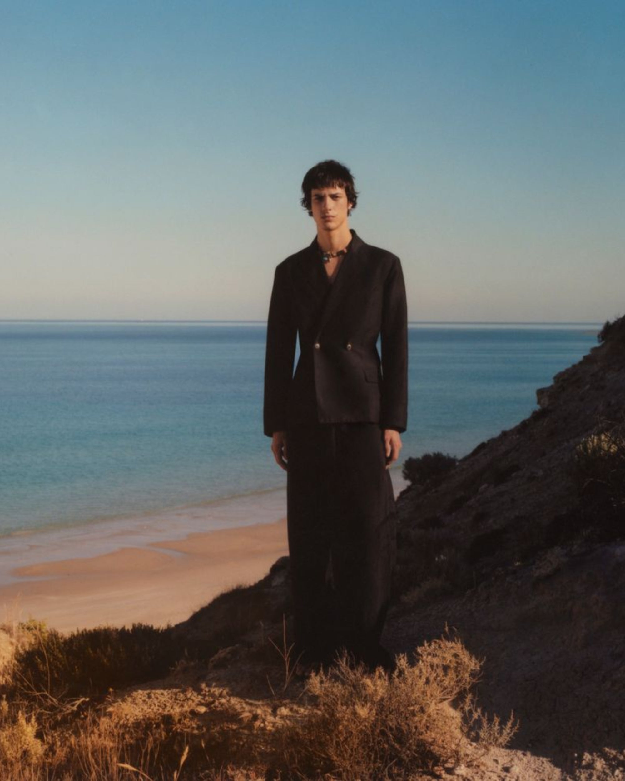 Campaign image of men's wool linen jacket and trousers.