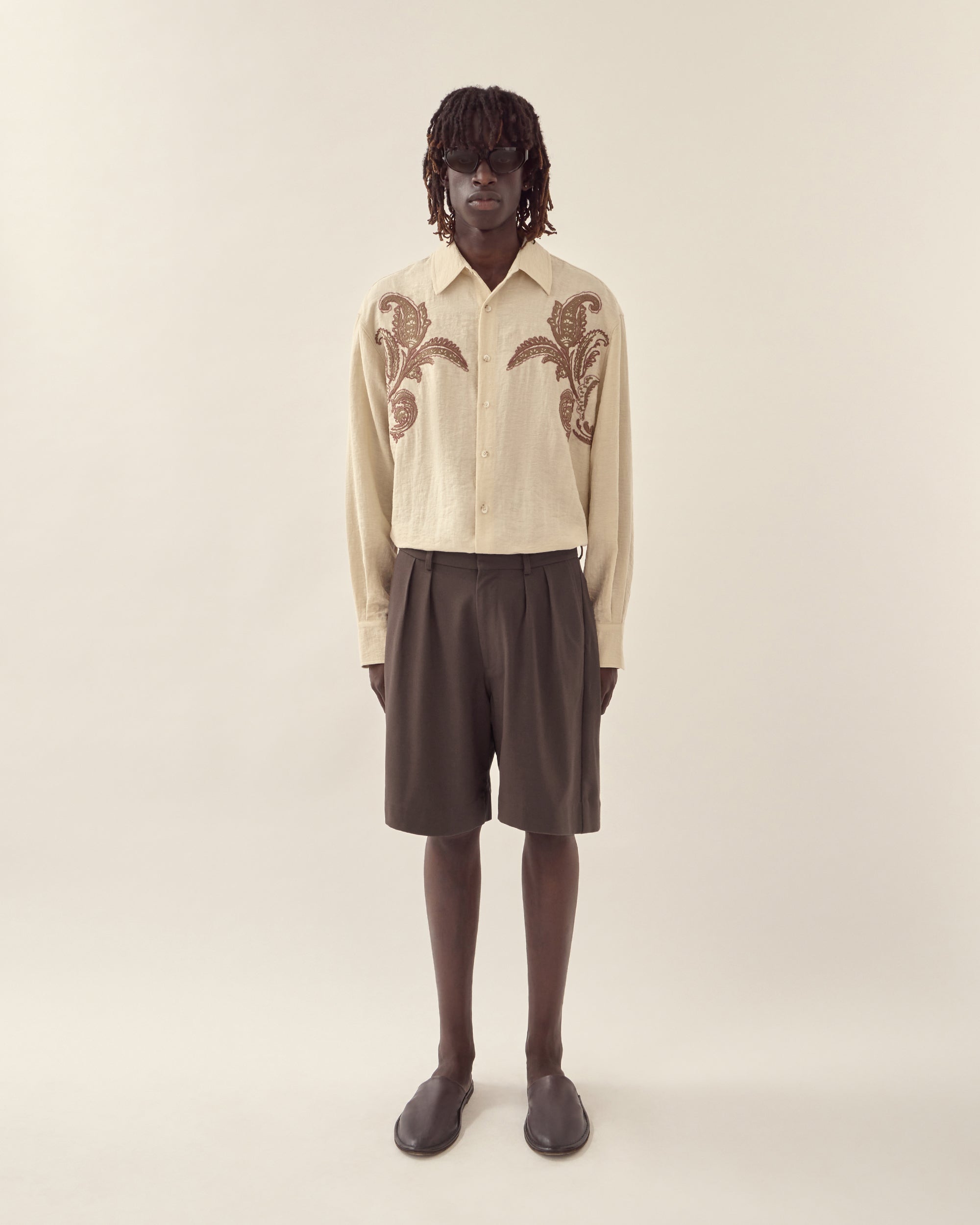 Front styled view of men's textured linen tailored short in chocolate.