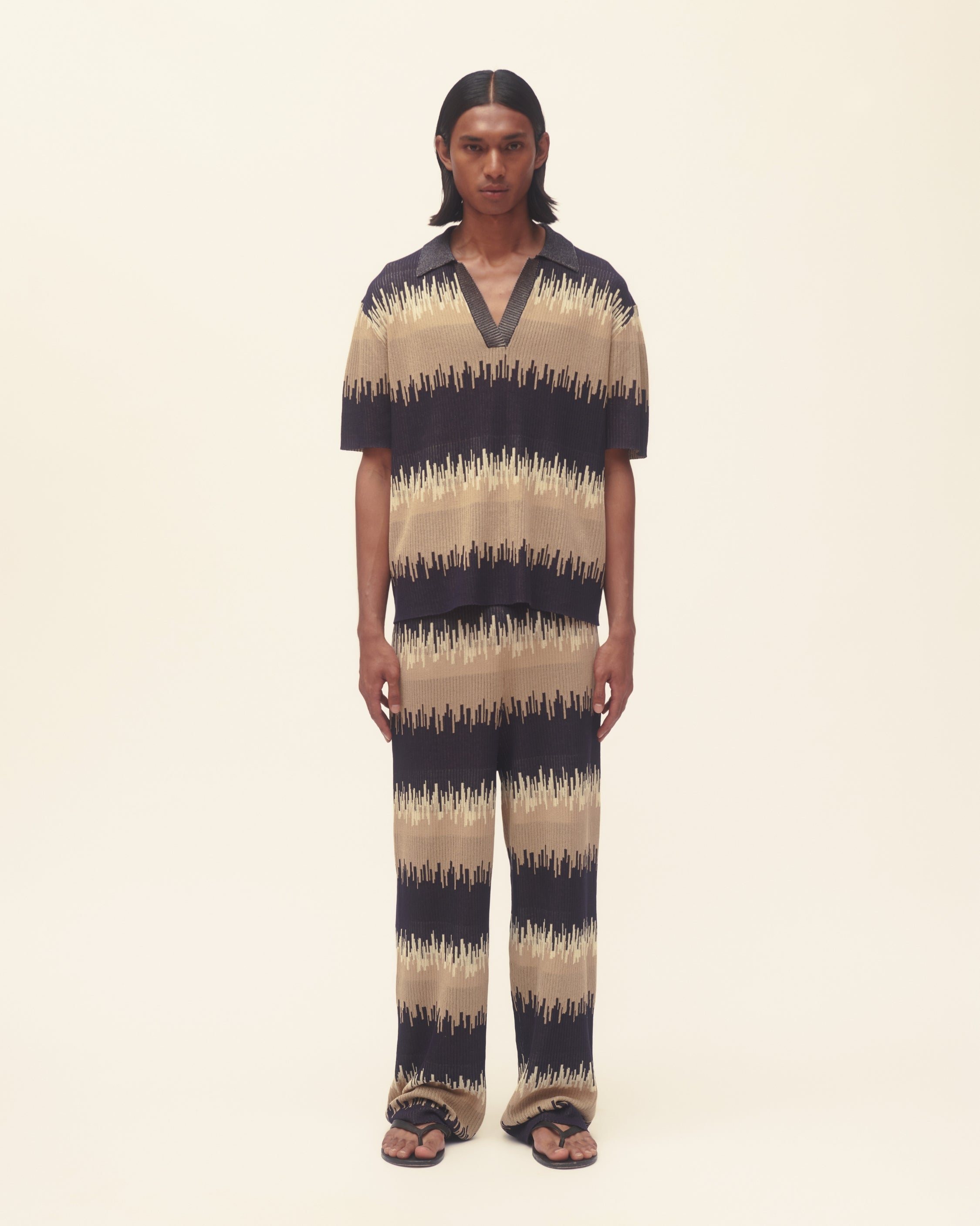 Person wearing a wavy print outfit on a plain background